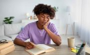 Teen looking glum whilst reading