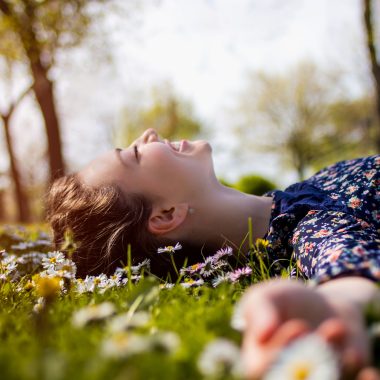 Girl lying in grass outdoors