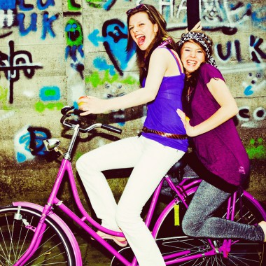 Two girls having fun on a bike