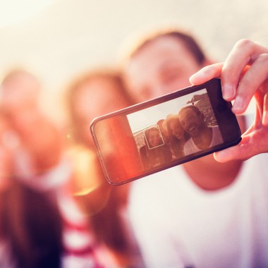 People taking selfie together on beach