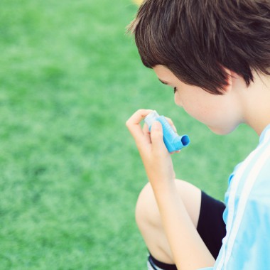 Boy using asthma inhaler