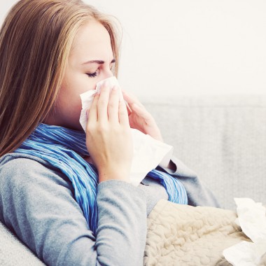 Girl blowing her nose