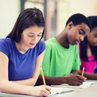 Girl and boy writing in class