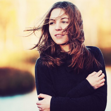 Girl outside with her hair being blown by the wind