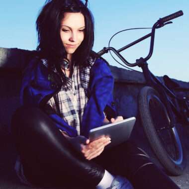 Young girl looking at her tablet