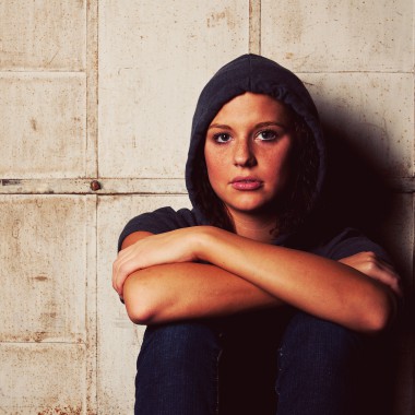 Girl in hoodie looking at camera