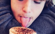 Boy licking cappucino