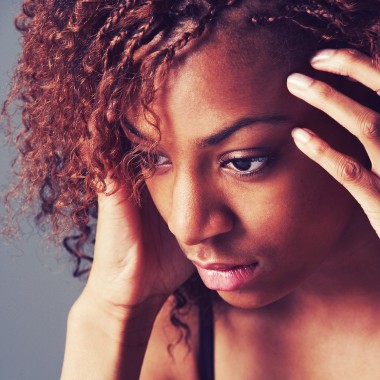 Girl with curly hair looking worried