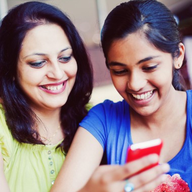 Mother and daughter looking at phone