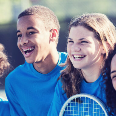 Young people playing tennis