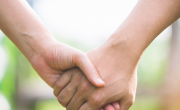 Adult holding young persons hand