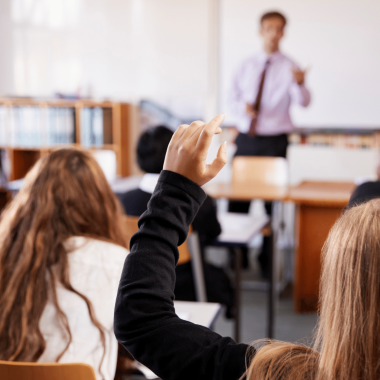 Raised hand in classroom