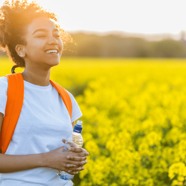 Woman walking through field